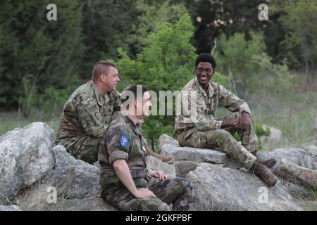 Navy Commander. W.L. Perry, left, jokes with Marine Capt. Ted