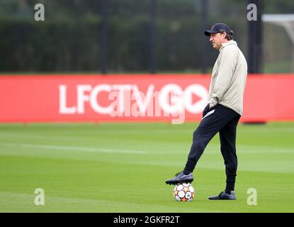 Kirkby, Knowsley, Merseyside, England, 14th September 2021: The AXA Training Centre, Kirkby, Knowsley, Merseyside, England: Liverpool FC training ahead of Champions League game versus AC Milan on 15th September: Liverpool assistant coach Peter Krawietz watches the players waming up Stock Photo