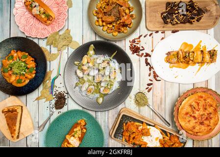 Set of recipes for fusion food of various nationalities. Clams in seafood sauce with Chinese noodles, mussels in sauce, fried eggs with beef tripe, gn Stock Photo