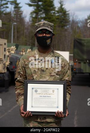 Staff Sgt. Dantè Davis, a military policeman with the 237th Military Police Company currently supporting the COVID-19 relief mission, receives an Army Achievement Medal and recognition during a ceremony April 11, 2021, at the New Hampshire National Guard Army Pembroke Regional Training Institute in Pembroke, New Hampshire. Davis called 911 and assisted a police officer in a violent encounter with a civilian driver on his commute home. Stock Photo