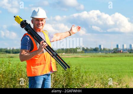 Engineer architect foreman on a construction site with a measuring device in his hands. Stock Photo