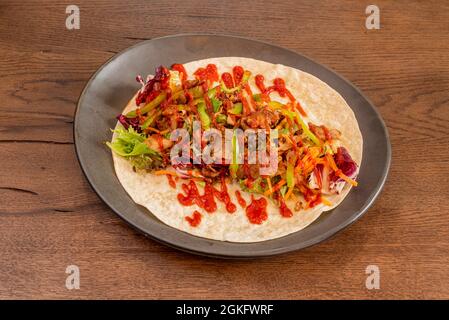 Open Lebanese Durum with Stewed Lamb, Peppers, Carrots and Kale Roa with Tomato Sauces and Mayonnaise on a Wheat Tortilla Stock Photo