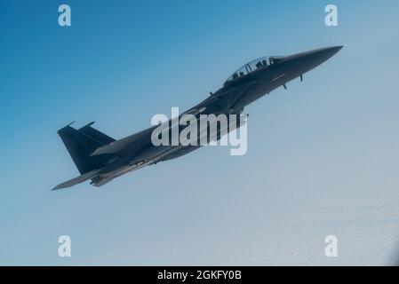 A U.S. Air Force F-15E Strike Eagle from Seymour Johnson Air Force Base, North Carolina, prepares to be refueled by a KC-46A Pegasus during an orientation flight out of Joint Base Andrews, Maryland, April 12, 2021. During the orientation flight, Air Force and Air Mobility Command leaders showcased the KC-46A Pegasus’s capabilities and aircrew proficiency to members of U.S. Congress, providing measurable progression of the airframe's growing operational capacity. Stock Photo