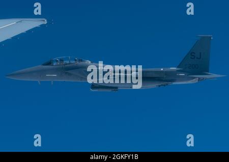 A U.S. Air Force F-15E Strike Eagle from Seymour Johnson Air Force Base, North Carolina, prepares to be refueled by a KC-46A Pegasus during an orientation flight out of Joint Base Andrews, Maryland, April 12, 2021. During the orientation flight, Air Force and Air Mobility Command leaders showcased the KC-46A Pegasus’s capabilities and aircrew proficiency to members of U.S. Congress, providing measurable progression of the airframe's growing operational capacity. Stock Photo