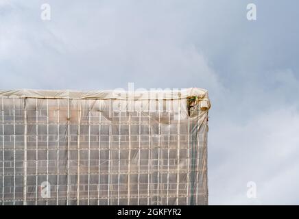 Building covered in plastic for renovations Stock Photo