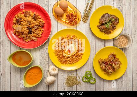 Typical dishes of popular Spanish gastronomy. Migas with fried egg, chickpea codido, fried artichokes with ham, Andalusian gazpacho, pork cheek, garli