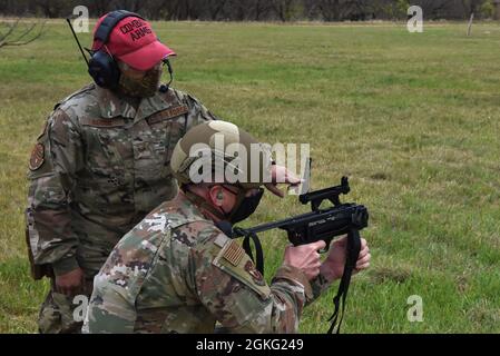 Staff Sgt Lolita Aguon, 7th Security Forces Squadron combat arms training and maintenance NCO in charge, instructs Maj. Gen. Mark Weatherington, 8th Air Force and Joint-Global Strike Operations Center commander, on weapon procedures at Dyess Air Force Base, Texas, April 13, 2021. During his visit, Weatherington was briefed on some of Dyess’ unique programs and recent innovations. Stock Photo