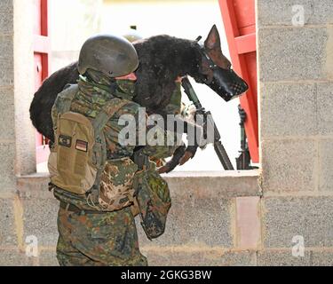 German Army (Bundeswehr) Cpl. (Stabsgefreiter) Kevin Koeckeritz moves a dog mannekin to secure location during a K-9 Tactical Combat Casualty Care Short Course in Baumholder, Germany April 13, 2021 . The 64th MED DET hosted a three day course that taught handlers and medics MWD life saving techniques and procedures. Stock Photo
