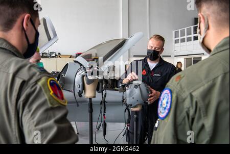 Glenn Snyder, Red 6 hardware developer, center, describes the hardware used for their augmented reality headsets in Santa Monica, Calif., April 13, 2021. Unlike the normal simulators or utilizing virtual reality, the 7th Bomb Wing is looking to train its pilots with new augmented reality technology. Stock Photo
