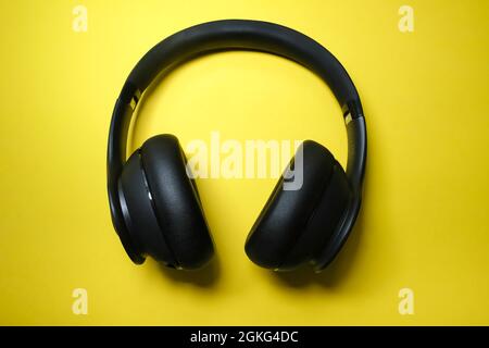 Studio shoot of a black headphone on yellow background Stock Photo
