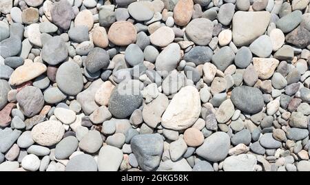 Beach dry pebble of various forms as natural background. Stock Photo