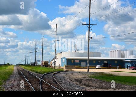 Train tracks along a manufacturing plant in Dyersville Iowa. Stock Photo