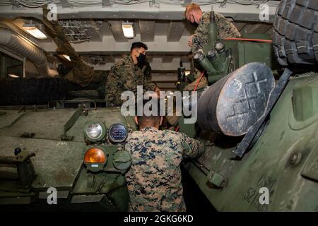 PACIFIC OCEAN (April 14, 2021) — Marines assigned to the 11th Marine Expeditionary Unit perform vehicle checks in the upper vehicle stowage area of amphibious transport dock USS Portland (LPD 27), April 14. Portland is underway conducting routine operations in U.S. Third Fleet. Stock Photo