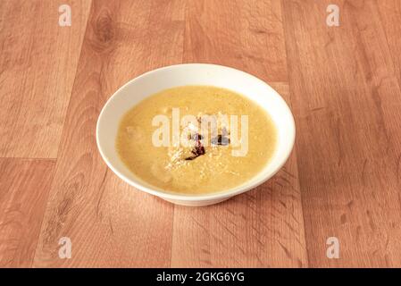 mild Indian curry, korma, yellow with dried fruits and dehydrated fruits with grated coconut inside a white bowl Stock Photo