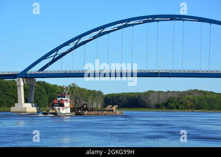 A Army Corp of Engineering tug pushes a barge loaded with construction materials up the Mississippi River past Savanna, Illinois. Stock Photo