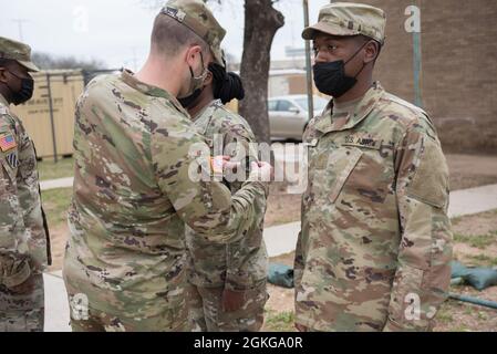 Tallahassee, Florida native and culinary specialist, Pfc. Jameilya Howard, 61st Quartermaster Battalion, receives her unit patch after completing the two-week Green Company cycle.  The Green Company is designed to create a lasting impact on all the Soldiers who come into the unit by showing them what right is, and not what it looks like. Stock Photo