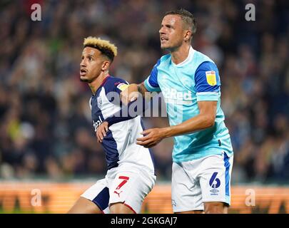 West Bromwich Albion's Callum Robinson (left) and Derby County's Phil Jagielka in action during the Sky Bet Championship match at The Hawthorns, West Bromwich. Picture date: Tuesday September 14, 2021. Stock Photo