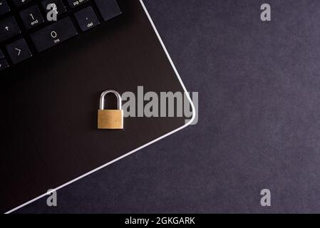 Cybersecurity concept, padlock on laptop computer keyboard. Stock Photo