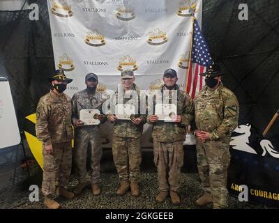 Lt. Col. Steven Jackowski and Command Sgt. Maj. Jesus Pena, the 2nd Battalion 8th Cavalry Regiment command team ,present Pfc. Deante Barnes, Spc. Blake Avenetti and Sgt. 1st Class David Hughes with Army Achievement Medals for attaining the battalion 'Top Gun' in Pabrade, Lithuania, April 15. During reconnaissance and security operations, there is a high probability that Scouts will come into direct contact with the enemy. It is vitally important that they are able to engage and destroy the enemy with overwhelming firepower to survive these encounters. Troopers from 2nd Batt. 8th Cav. Reg. scou Stock Photo