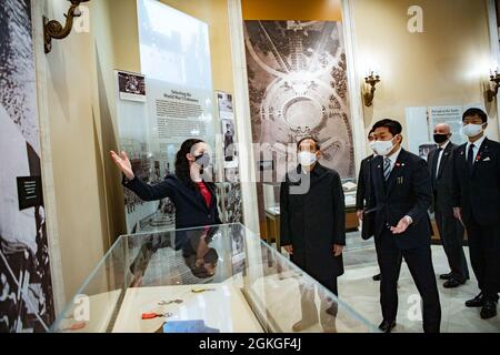 Allison Finkelstein (left), historian, Arlington National Cemetery; gives a tour of the Memorial Amphitheater Display Room to the Prime Minister of Japan Yoshihide Suga (second from left) at Arlington National Cemetery, Arlington, Virginia, April 16, 2021. Stock Photo