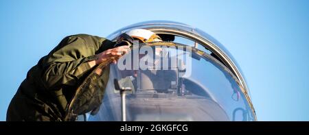 Marine Pfc. Byrd, a plane captain from Marine Attack Squadron 223, Cherry Point, North Carolina, prepares the cockpit of an AV-8B Harrier for an early morning flight on Gowen Field, Boise, Idaho, April 16, 2021. The aircraft are in Boise training with A-10 Thunderbolts and pilots from the 190th Fighter Squadron. Stock Photo