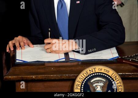 President Barack Obama signs the health insurance reform bill in the East Room of the White House, March 23, 2010. (Official White House Photo by Chuck Kennedy) This official White House photograph is being made available only for publication by news organizations and/or for personal use printing by the subject(s) of the photograph. The photograph may not be manipulated in any way and may not be used in commercial or political materials, advertisements, emails, products, promotions that in any way suggests approval or endorsement of the President, the First Family, or the White House. Stock Photo