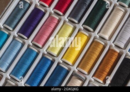 Sewing threads of different colors in a box Stock Photo
