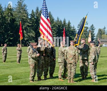 The Commander of the 5th Security Force Assistance Brigade, Brig. Gen. Curtis Taylor relinquished command to Col. Andrew Watson, who will serve as the interim commander, in a ceremony on Watkins Field, Joint Base Lewis-McChord, Washington, April 16, 2021. Brig. Gen. Curtis Taylor receives the colors of the 5th SFAB from Command Sgt. Maj. CSM Rob Craven before passing them to Lt. Gen. Leopoldo Quintas, Deputy Commanding General, U.S. Army Forces Command. Stock Photo
