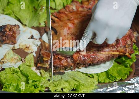 Roasted meat over an open fire, cooked in a special way.Barbecue is prepared of lamb or sheep meat and processed by slasher. chops the sheep. Many Stock Photo