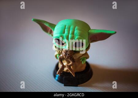 KYIV, UKRAINE - Aug 05, 2021: A small statuette of Master Yoda from Star Wars standing on a white table Stock Photo
