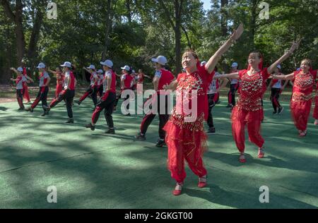 Women from Wenzhou, China in the Kai Xin Yizhu dance troupe celebrate their 6th anniversary with a performance in a Kissena Park in Queens, New York. Stock Photo