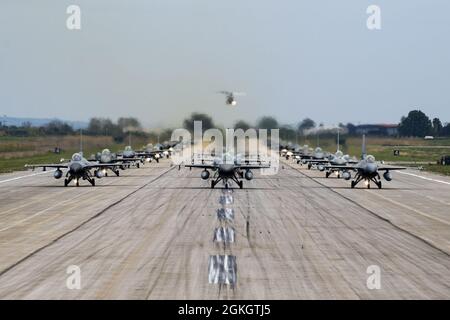 Aircraft from several countries participating in INIOCHOS 21 perform an elephant walk at Andravida Air Base, Greece, April 18, 2021. The 510th Fighter Squadron participated in INIOCHOS 21, a Hellenic air force-led, large force flying exercise. Participation in INIOCHOS 21 allowed U.S. Air Force pilots the opportunity to develop and improve air readiness and interoperability with allied and partner air forces. Stock Photo