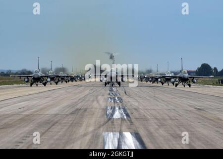 Aircraft from several countries participating in INIOCHOS 21 perform an elephant walk at Andravida Air Base, Greece, April 18, 2021. The 510th Fighter Squadron operated out of Andravida while participating in INIOCHOS 21, an annual exercise designed to provide advanced and realistic aircrew training. This training strengthens interoperability between allied and partner air forces during joint operations and air defenses to maintain joint readiness. Stock Photo