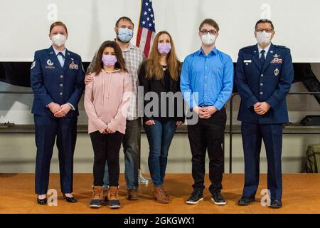 Brandon Kimball, second from right, poses for a photo with U.S. Air Force Col. James A. Quinn, USAFE-AFAFRICA director of space forces, far right, Tech. Sgt. Christine Mixon, 319th Recruiting Squadron enlisted accessions recruiter, far left, and his family after taking the oath of enlistment at Ramstein Air Base, Germany, April 19, 2021. Kimball is the first recruit from Ramstein to enlist directly into the U.S. Space Force. Stock Photo