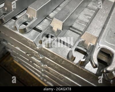 Aluminium alloy ingots stacked in the foreground, high-pressure die casting material, raw material, resources for the automotive industry Stock Photo