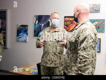 VIRGINIA BEACH, Va. (April 19, 2021)  - Rear Adm. Darin Via, commander, Naval Medical Forces Atlantic, speaks to Capt. Charles Eckhart, commander, Explosive Ordnance Disposal Group (EODGRU) Two, during a familiarization tour at the EODGRU2 STRIKE facility at Joint Expeditionary Base Little Creek-Fort Story. EOD STRIKE protects individuals and teams in the EOD force from debilitating stress through adaptability, recovery, and growth across the personal, social, cognitive and physical wellness domains. Stock Photo