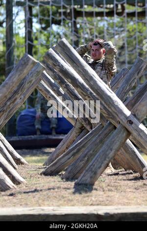 Sgt. Avery Tobar, Headquarters and Headquarters Command 505th Military Intelligence Brigade, works his way through an obstacle during the obstacle course event of the Military Intelligence Readiness Command (MIRC) Best Warrior Competition (BWC) at Joint Base San Antonio – Camp Bullis April 20, 2021. Events such as the obstacle course test the competitors’ capabilities and combat-readiness and help determine which Soldier will be named the MIRC’s Best Warrior. Stock Photo