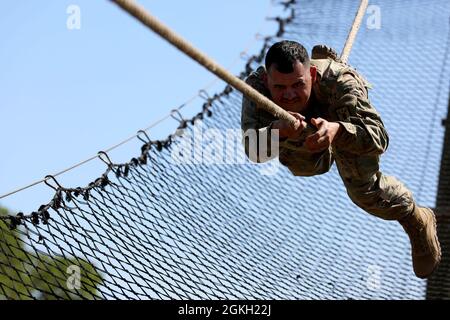 Sgt. Avery Tobar, Headquarters and Headquarters Command 505th Military Intelligence Brigade, nears the end of the obstacle course event during the Military Intelligence Readiness Command (MIRC) Best Warrior Competition (BWC) April 20, 2021, at Joint Base San Antonio – Camp Bullis. During the BWC soldiers from the MIRC spend a week competing in a variety of challenges including firing weapons, land navigation, the Army Combat Fitness Test and various mystery events. These challenges test the soldiers’ capabilities and combat-readiness to help determine the MIRC’s Best Warrior. Stock Photo
