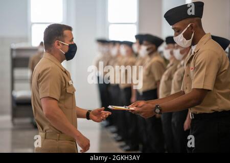The recruit chief petty officer for division 222 greets the inspector ...