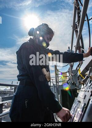 210420-N-SY758-1032 PORTSMOUTH, Va. (April 20, 2021) Aviation Boatswain’s Mate (Equipment) 3rd Class Ashleigh Martin, from Austin, Texas, operates a flight deck platform aboard the aircraft carrier USS George H. W. Bush (CVN 77). GHWB is currently in Norfolk Naval Shipyard for its Docking Planned Incremental Availability. Stock Photo