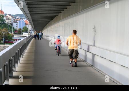 Bratislava, Slovakia - September 27, 2019 -  Father and son crossing the bridge. Stock Photo