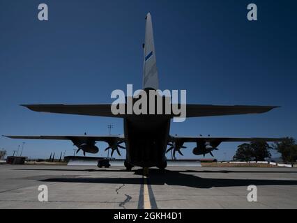 A C-130 Hercules assigned to the 152nd Airlift Wing at Reno Air National Guard Base, Nevada, sits on the flight line April 20, 2021, at Travis Air Force Base, California. The C-130’s arrival to Travis AFB abled the 775th Expeditionary Aeromedical Evacuation Squadron to gain familiarization with a Negatively Pressurized Conex Lite configuration in the aircraft. Stock Photo