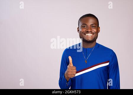 handsome young african man smiling and doing a thumbs up Stock Photo
