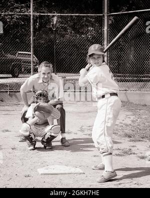 1960s TWO BOYS PITCHER AND CATCHER IN LITTLE LEague baseball