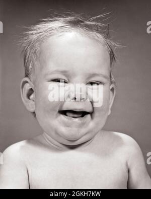 1960s LAUGHING BABY GIRL LOOKING AT CAMERA MOUTH OPEN TOOTHLESS - b6210 HAR001 HARS CONCEPTUAL COMEDY JOYFUL STYLISH TOOTHLESS GROWTH BABY GIRL BLACK AND WHITE CAUCASIAN ETHNICITY HAR001 OLD FASHIONED Stock Photo