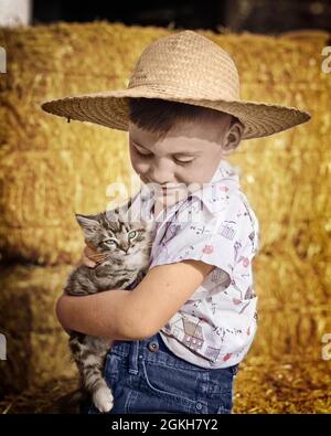 1940s 1950s SMILING COUNTRY BOY WEARING STRAW HAT HOLDING CUDDLING A TABBY CAT KITTEN SITTING AMONG FARM BARN HAY BALES - c4271c PUN001 HARS COPY SPACE FRIENDSHIP HALF-LENGTH CARING FARMING MALES PETS DENIM B&W TABBY HAPPINESS MAMMALS CHEERFUL FARMERS FELINE AMONG A SMILES CUDDLING JOYFUL FELINES BLUE JEANS COOPERATION HAY BALES JUVENILES KITTY MAMMAL TOGETHERNESS BALES BLACK AND WHITE CAUCASIAN ETHNICITY OLD FASHIONED Stock Photo