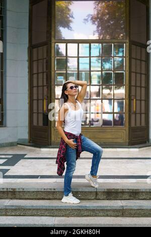 Free Photo | Glad lady in casual jeans outfit standing in confident pose  during photoshoot