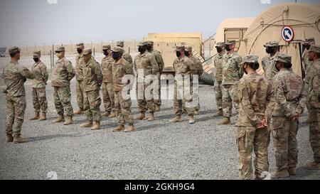 Lt. Col. Brian Kibitlewski, commander, Special Troops Battalion, 1st Theater Sustainment Command, addresses Soldiers during an awards ceremony at Camp Arifjan, Kuwait, Apr. 22, 2021. The team was an integral part of setting up the expeditionary command post that gives the TSC the ability to have a forward operating capability to provide operational level sustainment support to operations anywhere in the world. Stock Photo