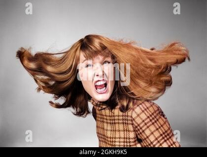 1960s ANGRY WOMAN LONG RED HAIR FLYING LOOKING AT CAMERA YELLING SNARLING GNASHING TEETH - g6741c HAR001 HARS GROWNUP LADIES PERSONS GROWN-UP TURNING YELLING MEAN HAIRS HEAD AND SHOULDERS DISTRESSED IRATE LONG-HAIRED EXCITEMENT FURY LONG HAIR YELL DISPLEASURE HOSTILITY SWIFT WHIRLING ANNOYANCE EMOTION EMOTIONAL EXCITING FURIOUS IMPATIENT IRRITATED NASTY RAGE WHIRL YOUNG ADULT WOMAN CAUCASIAN ETHNICITY DISPLEASED HAR001 HOSTILE INCENSED OLD FASHIONED Stock Photo