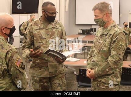 Brig. Gen. James M. Smith, the 31st Chief of Transportation and president of Army Logistics University (center) speaks to Gen. James McConville, the 40th Chief of Staff of the U.S. Army (right) and Maj. Gen. Rodney Fogg, commanding general of U.S. Army Combined Arms Support Command and Fort Lee (left), Thursday, April 22, 2021 at Fort Lee, Va. McConville visited the Army post reviewing CASCOM’s progress on Army priorities, emphasizing People First initiatives and training readiness. Stock Photo